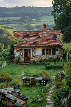 an old house in the middle of a lush green field