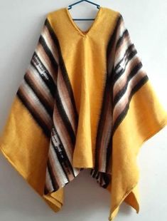 Soft and Warm shades of tan, brown and ivory exalt the fertile Andean earth. Working in luxurious alpaca. The warm but lightweight garment is woven on the hand loom.Unique Peruvian Alpaca Wool Men's Poncho Alpaca wool forms intricate geometric patterns in natural colors. Size: 56"  (145 cm )L   x  35" (80 cm)  W Brown Alpaca Cape Poncho, Brown Alpaca Poncho Cape, Brown Bohemian Cape Poncho, Bohemian Brown Cape Poncho, Hippie Brown Poncho For Winter, Bohemian Brown Cape Shawl, Hippie Brown Poncho For Festivals, Bohemian Brown Shawl Poncho, Bohemian Brown Poncho For Festivals