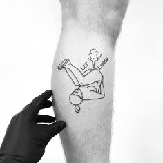 a black and white photo of a person with a tattoo on their leg