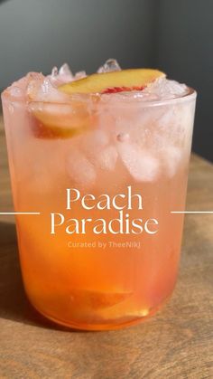 a peach paradise cocktail on a wooden table