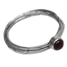 Minimalist yet magical this solitaire ring is handcrafted from three interlocking sterling silver bands. Ketut Sulastri creates his original design topping it with a single stone of garnet that glows deep red. Sterling Silver Jewelry With Polished Finish And Double Band, Sterling Silver Double Band Jewelry With Polished Finish, Double Band Sterling Silver Jewelry With Polished Finish, Sterling Silver Stackable Double Band Ring, Sterling Silver Double Band Stackable Promise Rings, Modern Sterling Silver Hand Forged Stackable Rings, Modern Hand-forged Sterling Silver Stackable Rings, Modern Sterling Silver Stackable Double Band Rings, Modern Sterling Silver Double Band Stackable Rings