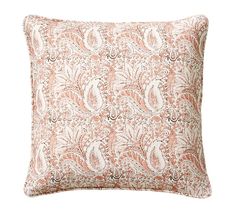 an orange and white pillow with paisley print on the front, sitting on a white background