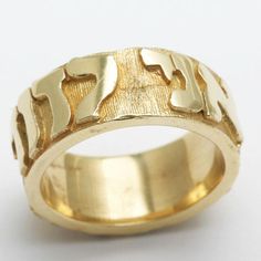 This stunning ring is made of 14k Yellow Gold. Its a very solid and substantial Jewish Wedding Band. It has the Jewish Wedding vow "Ani Le Dodi V'dodi Li" which translates to "I am to my beloved as my beloved is to me." This quote comes from Song of Songs. The band is 8mm wide and very thick and bulky. 8mm wide Ring is available in sizes 5 - 10 Please contact us for availability of additional sizes Allow 3 week delivery time for all wedding bands Also available in white gold Jewish Wedding Rings, Open Wedding Band, Jewish Marriage, Song Of Songs, Star Of David Pendant, Wide Ring, Jewish Wedding, Wide Rings, Wedding Band Ring