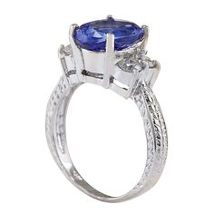 Stamped: 14K White Gold Total Ring Weight: 5.2 Grams Ring Length: N/ARing Width: N/A Gemstone Weight: Total Natural Tanzanite Weight is 3.54 Carat (Measures: 11.10x8.40 mm) Color: Blue Diamond Weight: Total Natural Diamond Weight is 0.65 Carat Quantity: 4 Color: F-G, Clarity: VS2-SI1 Face Measures: 11.10x13.80 mm Sku: [702279W] Oval Tanzanite Diamond Ring In White Gold, Elegant Oval Tanzanite Birthstone Ring, Platinum Rings With Gemstone, Oval Tanzanite Diamond Ring For Anniversary, Platinum Gemstone Ring, Elegant Tanzanite Birthstone Ring With Prong Setting, Luxury Three Stone Gemstones For Anniversary, Elegant Three Stone Birthstone Ring For Formal Occasions, Yellow Gold Tanzanite Rings