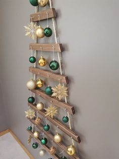 a wooden christmas tree with ornaments hanging from it