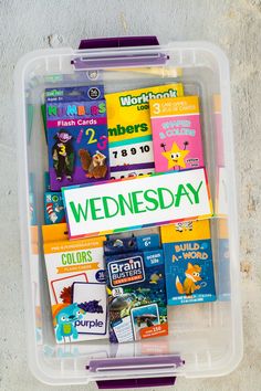 a plastic container filled with lots of different types of children's books and magazines