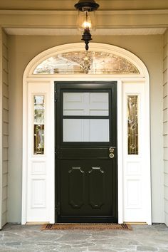 a black front door with two sidelights