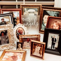 many different framed pictures on a table