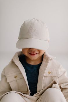 A brand new colour of our popular Nordique Ball Cap featuring a lightweight corduroy perfect for summer! Featuring tonal embroidery of the Petit Nordique trees on the front, and PETIT NORDIQUE written on the back. Infant size has a stretchy elastic back, while toddler, child and adult sizes have an adjustable buckle. Measurements: 0M - 6M: 18-19" circumference 6M - 2Y: 19.5"-22.5" circumference 2Y - 8Y: 21"- 24" circumference 8Y - Adult: 22.5"-25.5" circumference Our ball cap collection is PROUDLY DESIGNED AND MADE IN CANADA. Kids Baseball Caps, Book Dress, Tonal Embroidery, Baby Bjorn, Wrap Carrier, Play Yard, Cap Collection, Birthday Tee, Doll Play