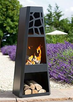 an outdoor fire pit in the middle of a garden