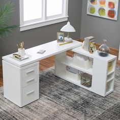 a white desk sitting on top of a rug next to a window