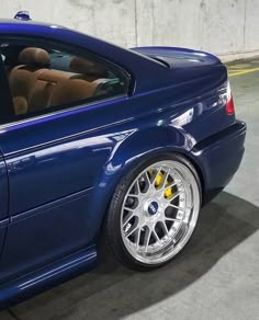 a blue sports car parked in a parking garage