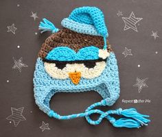 a crocheted blue and brown owl hat