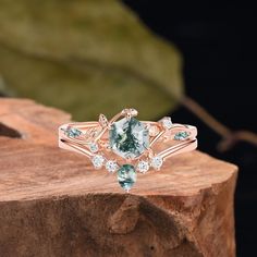 a green and white ring sitting on top of a piece of wood