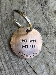 a metal keychain with the words still do written on it