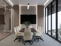 a conference table with white chairs and a television mounted to the wall