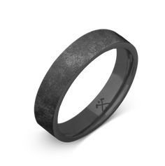 a black ceramic ring with an x in the center