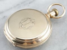 This antique size 16 pocket watch was made by the Elgin watch company of Chicago in the year 1880. Edged with an outer dial and classic times new roman numerals, this piece features a second counting dial as well. The face of this piece is crisp white, the dials clear and the anodized hands have retained a sleek blue hue. The reverse of the case is engraved with a handsome monogram, the inside of the case is fitted with a secondary lid in the locket style, which has not been engraved and could b Luxury Antique Pocket Watch With Polished Finish, Luxury Vintage Pocket Watch For Anniversary, Luxury Vintage Watches With Box Clasp, Victorian Yellow Gold Pocket Watch With Chronometer, Vintage Yellow Gold Pocket Watch With Subdials, Antique Medallion Pocket Watch With Metal Dial, Antique Pocket Watch With Metal Dial Medallion, Antique Pocket Watch With Subdials, Victorian Pocket Watch With Round Dial For Formal Occasions