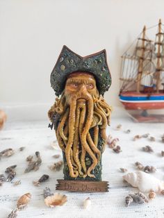 a figurine of an octopus with a pirate's hat and beard sitting on a table