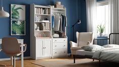 a bedroom with blue walls, white furniture and a large open bookcase in the corner