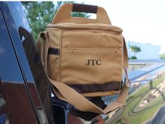 a brown bag sitting on the back of a car