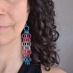 Go big or go home with these dramatic earrings in pink, blue and white links to best match the Transgender Pride flag. Available in LONG and MEDIUM lengths.  🌈 LONG earrings  ∙ lightweight - each LONG earring weighs under 6g (about the weight 3 US dimes)   ∙ approximately 4.5" long from top of earwire 🌈 MEDIUM earrings ∙ lightweight - each Medium earring weighs approximately 2.5g (about the weight of a US penny)   ∙ approximately 3" long 🌈 Aluminum links on stainless steel earwire The design for both earrings is the same; the difference in length is created by using larger links for the long earrings. If you prefer sterling or hypoallergenic niobium earwire, feel free to request an upgrade here: https://www.etsy.com/listing/1157028577/ Chainmaille Earrings, Trans Pride Flag, Dramatic Earrings, Us Penny, Beaded Jewelry Earrings, Go Big Or Go Home, Beading Inspiration, Long Earring, Pride Colors