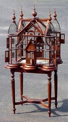 a wooden birdcage sitting on top of a table