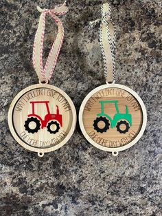 two wooden christmas ornaments with tractors on them