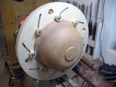 a large wooden object sitting on top of a table next to other tools and equipment