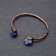 GemFormingStudio D E T A I L S Tanzanite Bangle | Adjustable Bangle | Bangle For Her | Bangle For Women | Gift For Her | Gift For Women | Gemstone Bangle [GFS2855] Stone Size: 12x11 mm Weight: 10.86 gm Bangle Size: 3 inches Color: purple Material: Copper Polish: Copper Antique Plated . Contact us for wholesale prices. R I N G S https://www.etsy.com/in-en/shop/GemFormingStudio?section_id=22783374 B E A D S https://www.etsy.com/in-en/shop/GemFormingStudio?section_id=22828835 W A N D S https://www. Adjustable Sapphire Bracelet Jewelry, Adjustable Sapphire Crystal Bracelet, Gemstone Bangle Bracelets, How To Polish Copper, Adjustable Bangle Bracelet, Gemstone Bangle, Antique Bracelets, Antique Plates, Tanzanite Gemstone