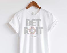 Welcome to HappymanGeneral!  This minimalist, stylish Rainbow DETROIT T-shirt is ready to celebrate PRIDE with you. Let's get party started! Our products will make the perfect gift for any age and occasion. Hope our products make you smile and light up your day. https://HappymanGeneral.etsy.com // P R O D U C T  D E T A I L S  Gray Lettering with Retro colored Rainbow Bella + Canvas 3001 Jersey Short Sleeve Tee READ:  How do unisex shirts fit for women? The unisex tees are sold in standard men's Pride Graphic Print Short Sleeve T-shirt, Pride Slogan T-shirt With Short Sleeves, White Rainbow Pride T-shirt, Rainbow Graphic Print T-shirt For Pride, Pride Graphic Cotton T-shirt, Got Party, Pride Tshirts, Lgbtq Pride, Retro Shirts