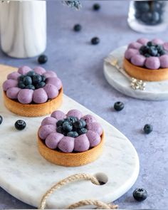 two small cakes with blueberries on top