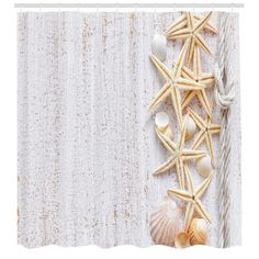 the curtain is decorated with seashells and starfish on white sheer drapes