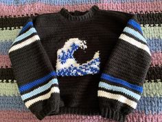 a knitted sweater with a blue and white wave on it