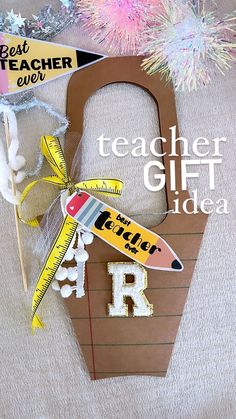 a teacher's gift idea made out of construction paper, scissors and other crafting supplies