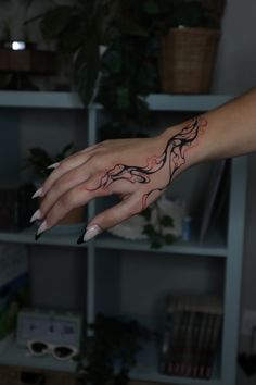 a woman's hand with a tattoo on it