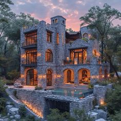 a large stone house with lots of windows and lights on it's front facade