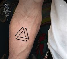 a couple of people with tattoos on their arms and legs, one has a triangle tattoo on it's arm