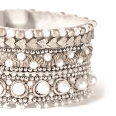 Complete your outfit with the stunning Orion Bracelet, adorned with hand-embellished pearls and a touch of metallic shine. This statement bracelet adds a touch of elegance and sophistication to any look. Show off your unique style with the Orion Bracelet. Hand embellished statement bracelet. Cotton woven Glass beads Metallic thread Pearl Suede backing Brass Magnet closure Size: Length 1.5" | Width 7" Please note: Due to the handmade nature of our collection, colors and patterns may vary slightly Chic Silver Bracelets For Wedding, Elegant Silver Bracelets For Festive Occasions, Elegant Silver Beaded Bracelets With Strap, Bohemian Pearl Bracelet For Parties, Silver Beaded Bracelets With Strap For Party, Silver Pearl Bracelet For Party, Luxury White Bracelets For Parties, Silver Beaded Pearl Bracelet For Party, Luxury Silver Beaded Bracelets For Party