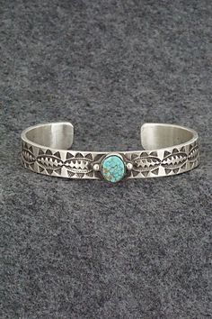 This Kingman turquoise and sterling silver bracelet was made by Navajo silversmith Calvin Martinez. The inside is signed C MTZ, Navajo and stamped sterling.Size: 5 5/8" (will fit up to a 6 5/8" wrist)Gap: 1"Length: 3/8"Free shipping on all orders! We ship with USPS and always include tracking. All orders ship within a day of payment.Returns are accepted up to 30 days after you receive your order. Just send us a message. Our shop offers cash back or store credit. The item must be returned in new Navajo Bracelet, Kingman Turquoise, Sterling Silver Bracelet, Native American Jewelry, Free Jewelry, Sterling Silver Bracelets, Silver Bracelet, Jewelry Watches, Jewelry Bracelets