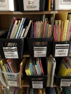 several bins filled with books on top of a shelf