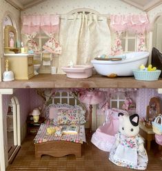 a doll house with furniture and accessories on the shelves, including a bed, bathtub, sink and other items