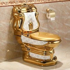 a gold toilet in the middle of a bathroom