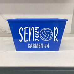 a blue container with the word seme or written in white on it, sitting on top of a counter