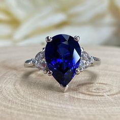 Blue Sapphire Pear Shape Engagement Ring, Blue Sapphire And Moissanite Pear Shape Three Stone Wedding Ring, Sapphire Birthstone Ring #6811 #SeptemberBirthstone #WeddingRing #EngagementRings #PromiseRing #PearShapeRing #AnniversaryGift #SapphireRing #14kGoldRing #EngagementRing #GiftForHer Sapphire Pear Wedding Ring Set, Luxury Teardrop Sapphire Wedding Ring, Tear Drop Blue Engagement Ring, Luxury Sapphire Ring With Prong Setting For Promise, Luxury Elegant Teardrop Sapphire Ring, Pear Shaped Blue Ring, Luxury Teardrop Sapphire Ring In Elegant Style, Luxury Sapphire Promise Ring For Engagement, Luxury Pear-shaped Sapphire Ring