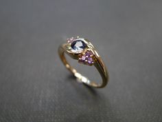 Product Specifications: - 4mm Round Natural Round Brilliant Cut Blue Sapphire - 6 Round Brilliant cut Natural Amethyst - 14K yellow gold - Ring Width: 2.3mm Currently made to order pieces may take up to 10-15 business days to complete, or let me know if you need it urgent. You may also like: A similar ring with 0.25ct diamond and amethyst, https://www.etsy.com/listing/77948809/diamonds-wedding-ring-with-amethyst-in It's easy to create jewelry that's perfect for you. Change the materials to suit Modern Sapphire Ring With Gemstone Accents As Gift, Sapphire Amethyst Ring With Accent Stones For Promise, Purple Sapphire Rings With Accent Stones, Formal Purple Sapphire Rings, Modern Tanzanite Sapphire Promise Ring, Modern Amethyst Ring With Accent Stones For Wedding, Modern Amethyst Wedding Ring With Accent Stones, Blue Amethyst Ring Elegant Style, Blue Amethyst Elegant Ring