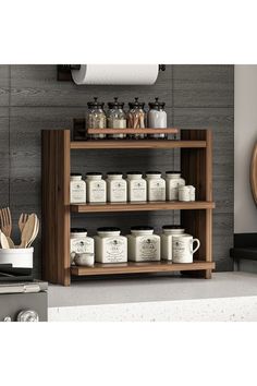 a wooden shelf filled with jars and utensils