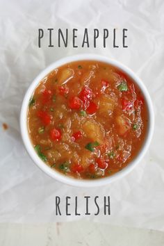 a bowl of pineapple relish on top of a piece of wax paper with the words pineapple relish above it