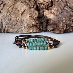 Beautiful Opaque Turquoise Sea Foam Colored beaded unisex cord bracelet for men and women of all ages.  This adjustable waterproof bracelet is made with strong lightweight 1mm waxed polyester/nylon cord that is fast drying, color fast, and non fraying.  There are seven stunning high quality 4mm Miyuki Picasso glass beads.  We've also added 4mm stainless steel beads to flank the sides of the glass beads, and two little coordinating 3mm beads that will move freely on your cord.  For the stainless beads you get to choose from three colors.  Our video and listing photos showcase all of our Miyuki Picasso bead color bracelets.  Follow the link below to order your bracelet in one of the other bead colors. VIEW ALL OUR CORD BRACELETS HERE: https://www.etsy.com/shop/OtterlyCharmingUSA?ref=seller-p Turquoise Beaded Bracelets With 8mm Beads For Beach, Adjustable Turquoise Wrap Bracelet For Festival, Adjustable Turquoise Resizable Bracelet, Adjustable Turquoise Hand-strung Wrap Bracelet, Adjustable Turquoise Hand-strung Beaded Bracelets, Adjustable Hand-strung Turquoise Beaded Bracelets, Adjustable Turquoise Wrap Bracelet, Adjustable Turquoise Bracelets With Sliding Knot, Adjustable Turquoise Bracelet With Sliding Knot