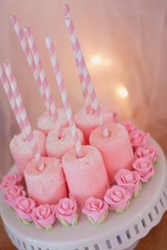 there is a cake that has candles in the shape of hearts and roses on it